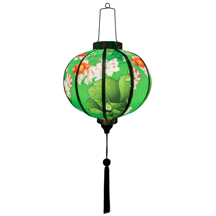 Glowing handcrafted Hoi An lantern with goldfish and floral design on green fabric, traditional Vietnamese home decor.