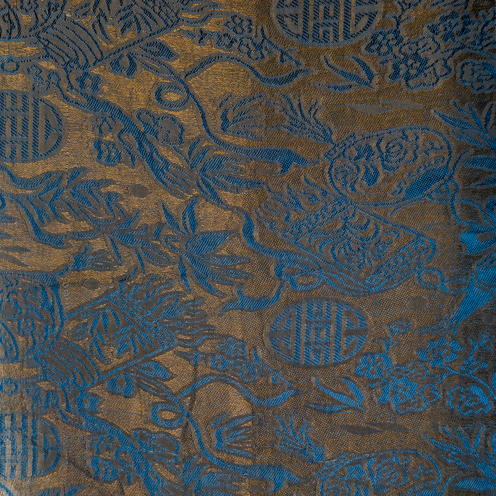 Textured Jacquard silk fabric with blue and gold colour patterns