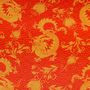 Orange fabric with gold dragon and floral patterns