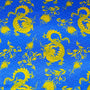Polyester silk fabric used to create silk lanterns featuring a pattern of golden yellow dragons and flowers on a blue background with sea swirls.