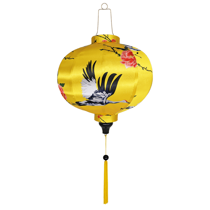 Round Vietnamese Hoi An lantern with yellow tassel a print of herons and pink roses on a bright yellow background.
