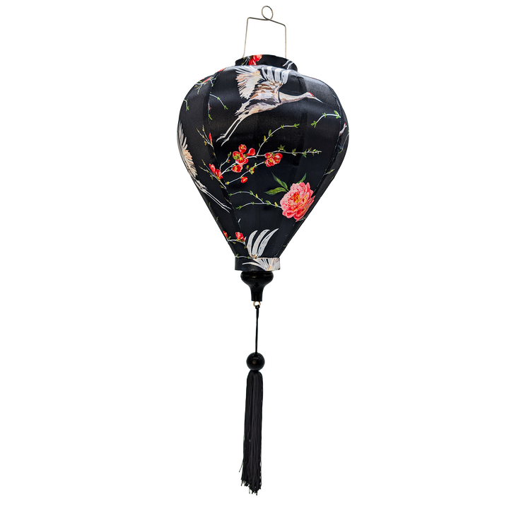 balloon shaped Vietnamese lantern made in Hoi An with a print of heron birds in flight surrounded by pink flowers on striking black background