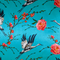 Polyester silk blue fabric with print of large herons flying amongst pink roses.