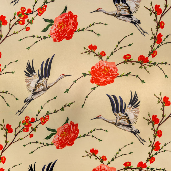 Polyester silk fabric with a pattern of herons in flight and red flowers on a beige background