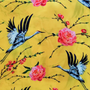 Polyester silk fabric with heron birds and  pink roses on a bright yellow.