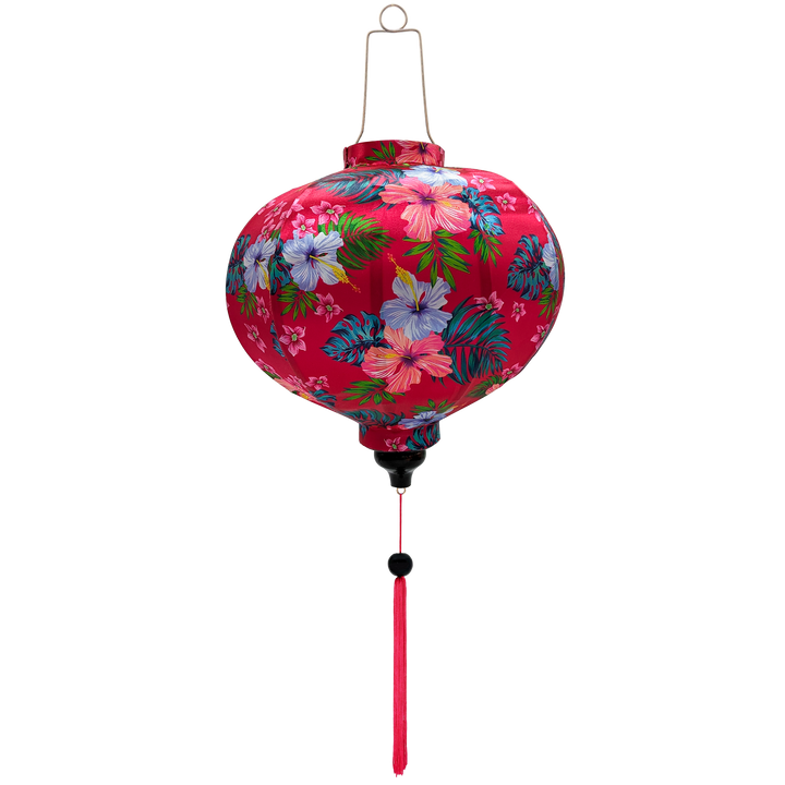Round Vietnamese silk lantern with hibiscus flowers are set against a bright hot pink, with green and teal leaves