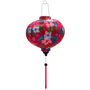 Round Vietnamese silk lantern with hibiscus flowers are set against a bright hot pink, with green and teal leaves