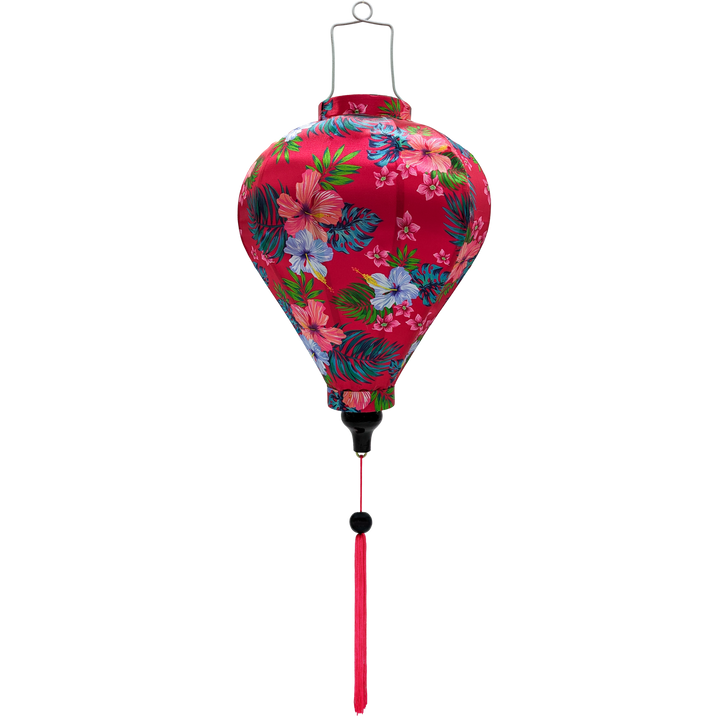 Balloon shaped Vietnamese silk lantern with hibiscus flowers set against a bright hot pink background.