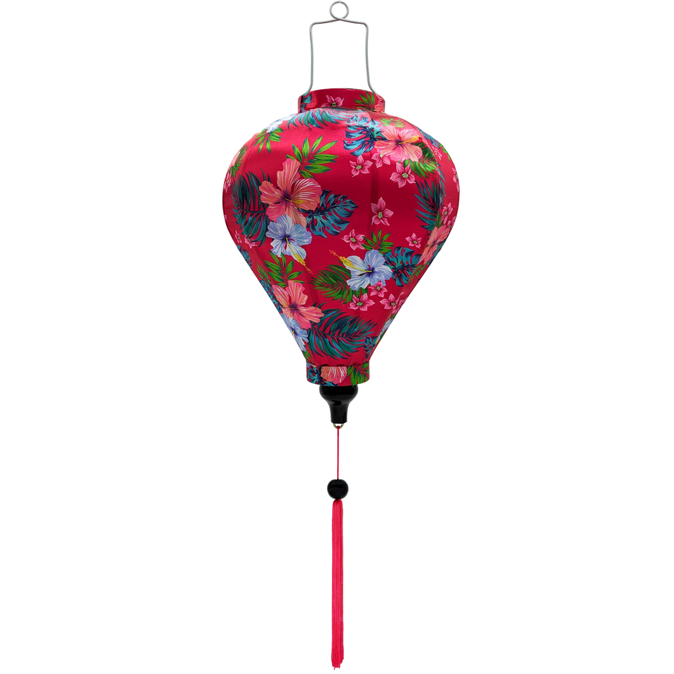 Balloon shaped Vietnamese silk lantern with hibiscus flowers set against a bright hot pink background.