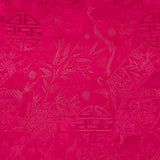 Close up of jacquard silk fabric with intricate patterns of bamboo, lanterns and symbols in hot pink colour.