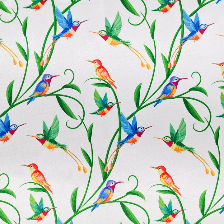 Polyester silk fabric with hummingbirds sitting and flying amongst plants on white background used to create Vietnamese lanterns.