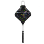 Lozenge shaped Vietnamese Hoi An Lantern with print of colourful cross stitched hummingbirds in flight amongst blue bell flowers and bright green leaves on black background. 