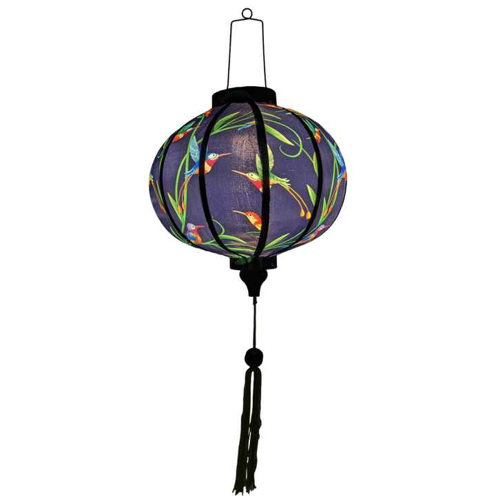 A round polyester silk Vietnamese Hoi An lantern lit from the inside using an external light which is placed inside.