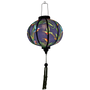 A round polyester silk Vietnamese Hoi An lantern lit from the inside using an external light which is placed inside.
