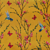 Yellow polyester silk fabric with a print of little hummingbirds mid-flight hunting nectar from orange flowers with red butterflies.