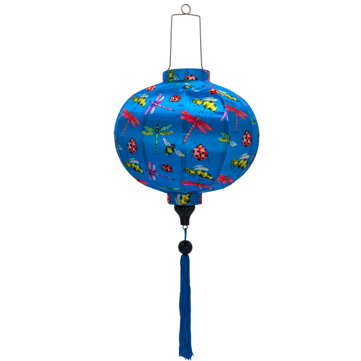 A round shaped lantern with a print of dragonflies, lady bugs and bees on bright blue background.