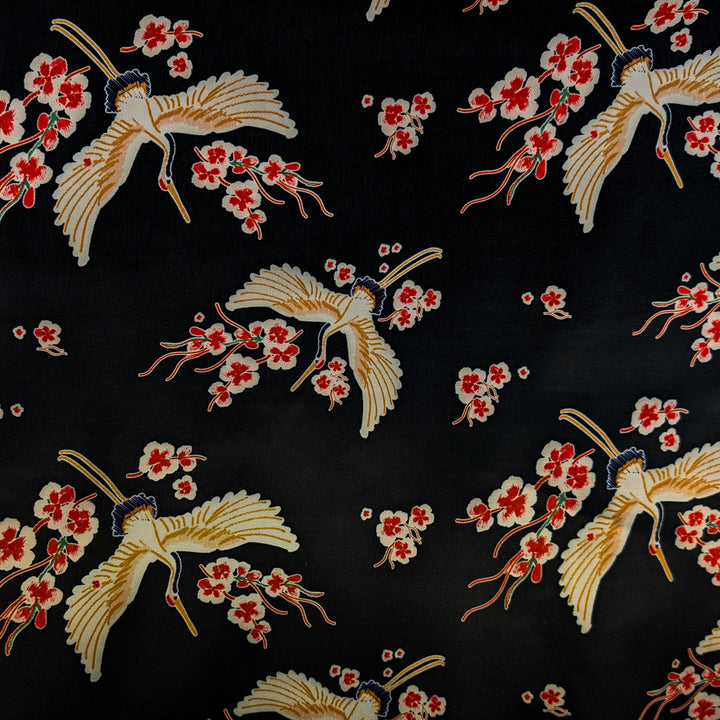 Embroidered pattern of birds and flowers on a black background