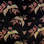 Embroidered pattern of birds and flowers on a black background