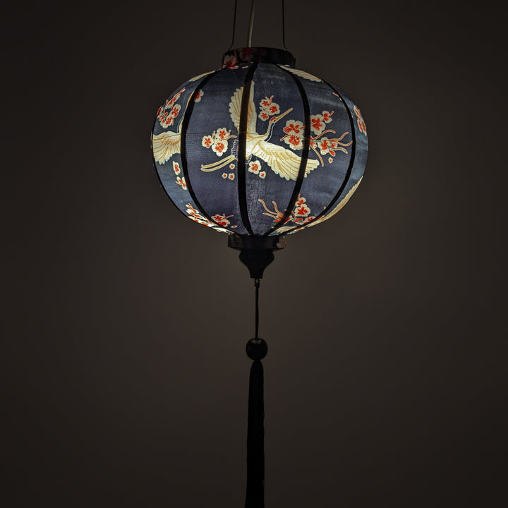 Glowing round lantern with floral design on a dark background