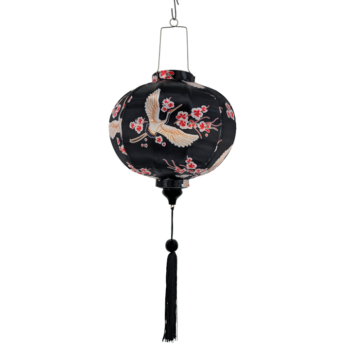 Round lantern with floral and bird patterns on a black background