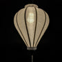 Glowing Hoi An silk lantern in a balloon shape, crafted from luxurious white jacquard fabric with intricate floral patterns woven into the material. 
