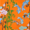 Orange polyester silk fabric with an illustration of Koi fish swimming around bamboo and pink lotus flowers.