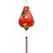 Garlic shaped Vietnamese lantern with a red tassel and print of large yellow koi fish swimming amidst swirls of white and thick black calligraphy.