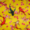 Polyester silk fabric with a design of koi fish swimming among cherry blossoms on a bold yellow background.