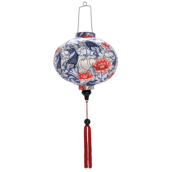 Round Vietnamese lantern with red tassels and a print featuring koi fish and red lotus flowers.