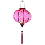 Glowing Round shaped Vietnamese lantern with pink tassels featuring a design of cranes, lanterns, firecrackers, and blooms of pink and yellow on a brilliant pink background. 