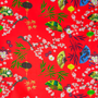 Up close polyester silk fabric with black, yellow and green lanterns and multi colour fans surrounded by white cherry blossoms on a bold red background.