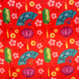 Decorative pattern with lanterns, fans, and flowers on a red background