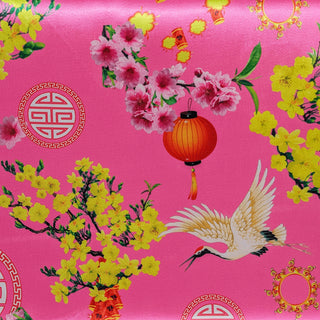 Polyester silk fabric used to created Hoi An Lanterns featuring a design of cranes, traditional lanterns, firecrackers, and pink and yellow blooms on a vibrant pink background.