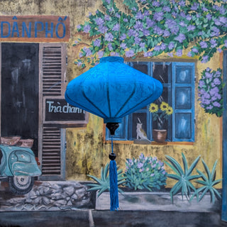 Light blue jacquard silk UFO shaped lantern hanging in front of a hand painted mural with flowers and a scooter.