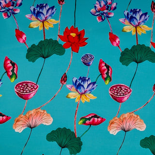Polyester silk fabric with illustrations of lotus flowers in full bloom against a vibrant turquoise-blue background.