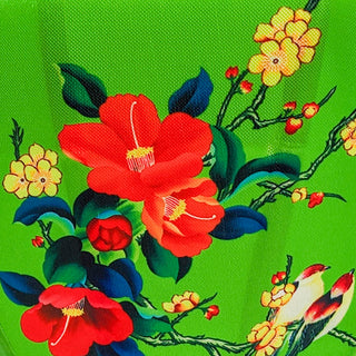 Polyester silk fabric used to create Hoi An Lanterns featuring love birds sitting in a tree with red and yellow flowers on a green background.