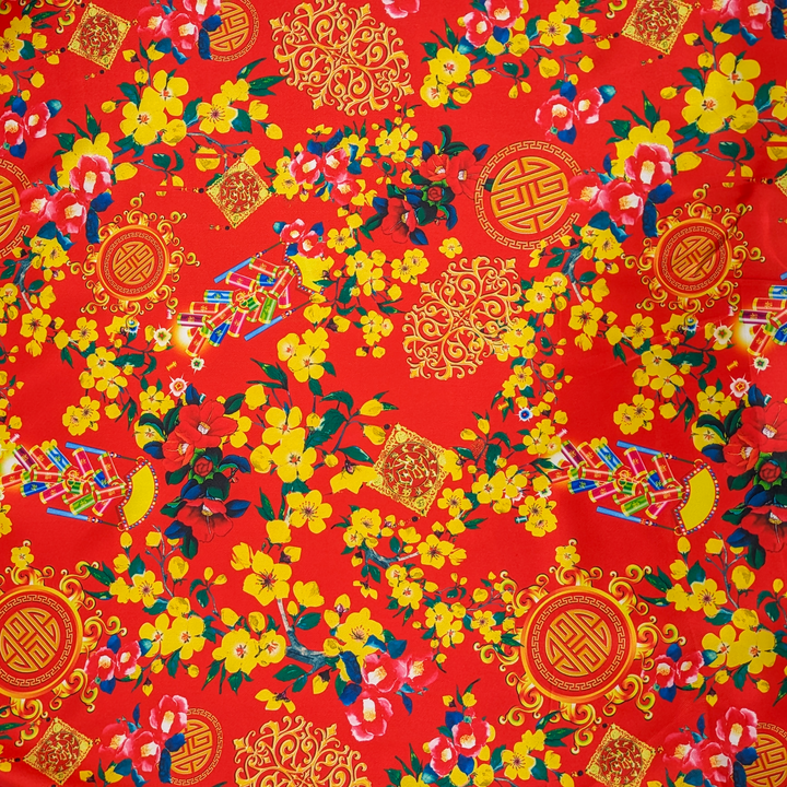 Red polyester silk fabric with print of yellow flowers and firecrackers.