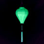 A balloon shaped mint green neon uv lantern with neon tassel.