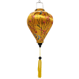 Balloon shaped Vietnamese Lantern with yellow tassel featuring a print of little hummingbirds mid-flight hunting nectar from orange flowers with red butterflies.