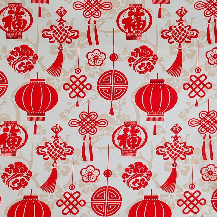 Polyester silk fabric featuring lanterns, traditional decorations and a luxurious red and creamy gold colour scheme.