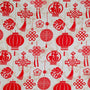 Polyester silk fabric featuring lanterns, traditional decorations and a luxurious red and creamy gold colour scheme.