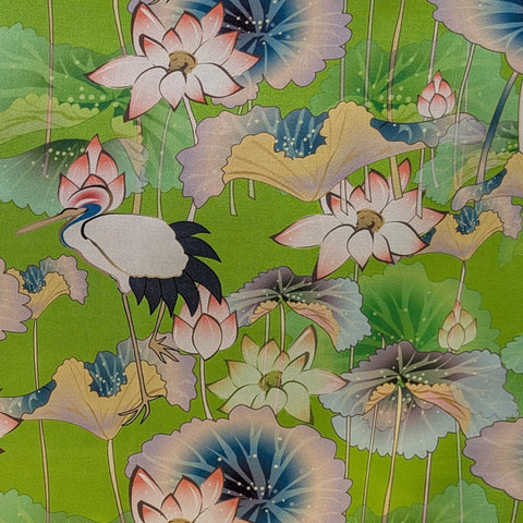 Decorative fabric with stork and lotus flowers on a green background