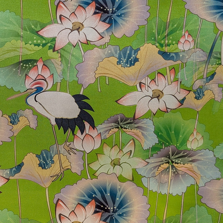 Decorative fabric with stork and lotus flowers on a green background
