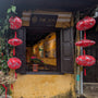 The Son Bistro with lanterns featuring cranes in flight on red background.