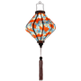 Glowing decorative lantern with an elegant paisley and feather motif, ideal for creating a warm and stylish ambiance.

