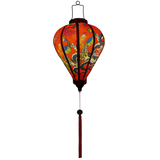 Glowing Balloon shaped lantern with red tassel adorned with intricate prints of dragons, peacocks, and butterflies against a striking red background.