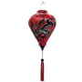 Balloon shaped lantern with red tassel adorned with intricate prints of dragons, peacocks, and butterflies against a striking red background.