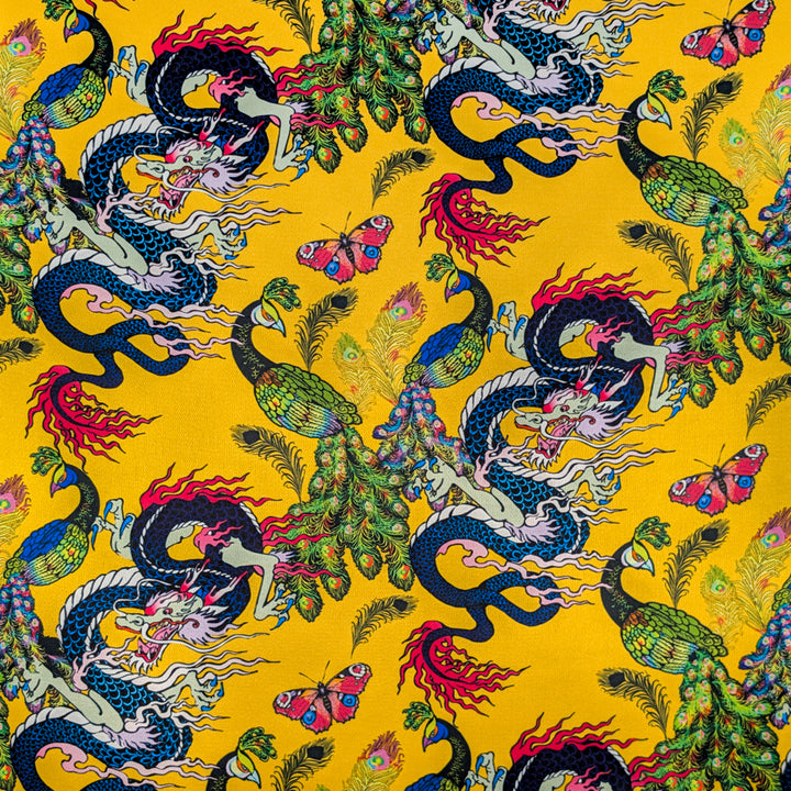 Yellow silk fabric with colourful pattern of dragons, peacocks, and butterflies 
