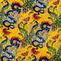 Yellow silk fabric with colourful pattern of dragons, peacocks, and butterflies 