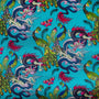 Close up of polyester silk fabric with flamboyant peacocks, butterflies and dragons against a striking blue background.
